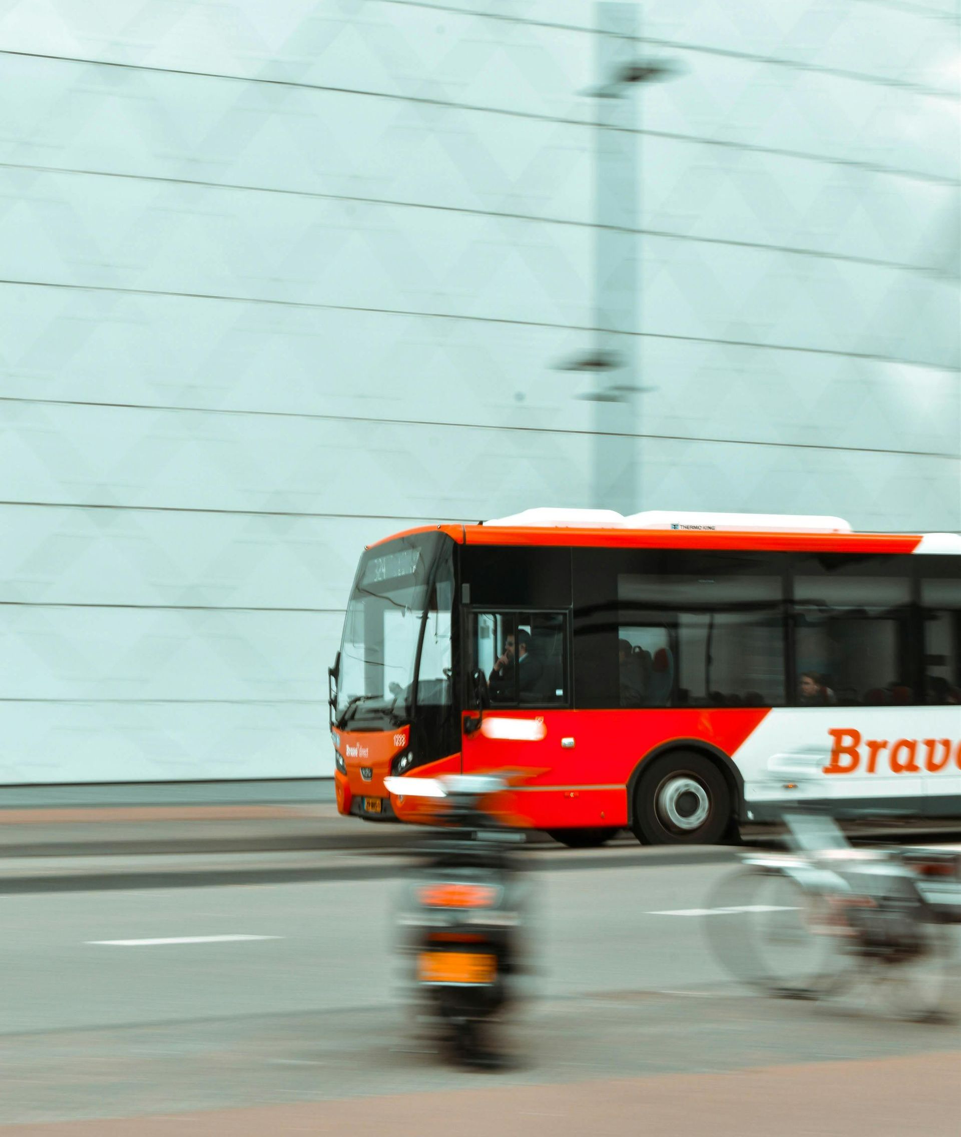 A red and white bus with the word brave on it