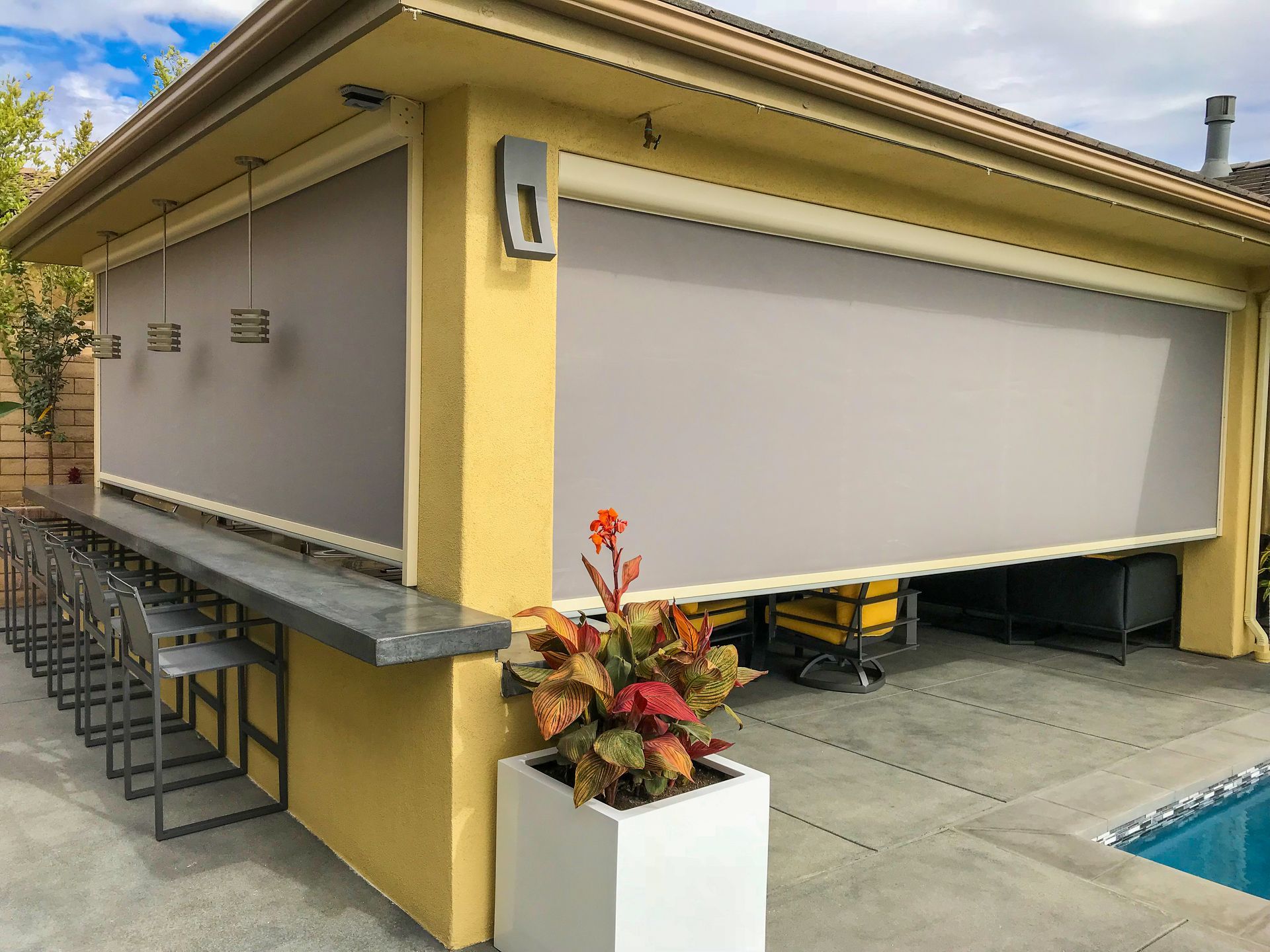 a house with a patio area and a swimming pool .| Jackson, MS | French Awning an Screen Co