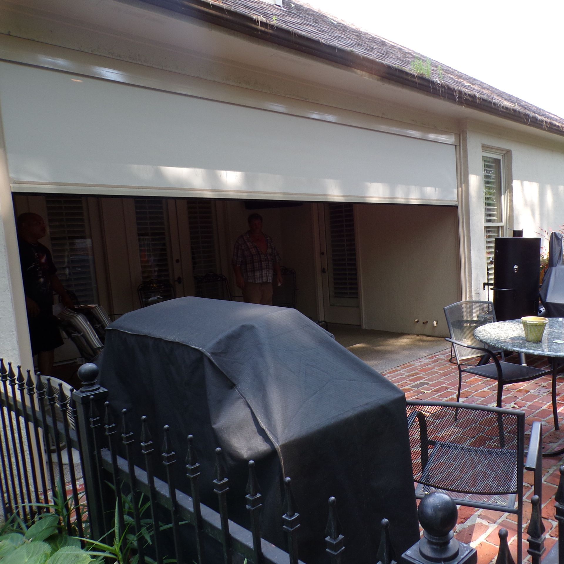 a balcony with a view of a lake and houses| Jackson, MS | French Awning an Screen Co