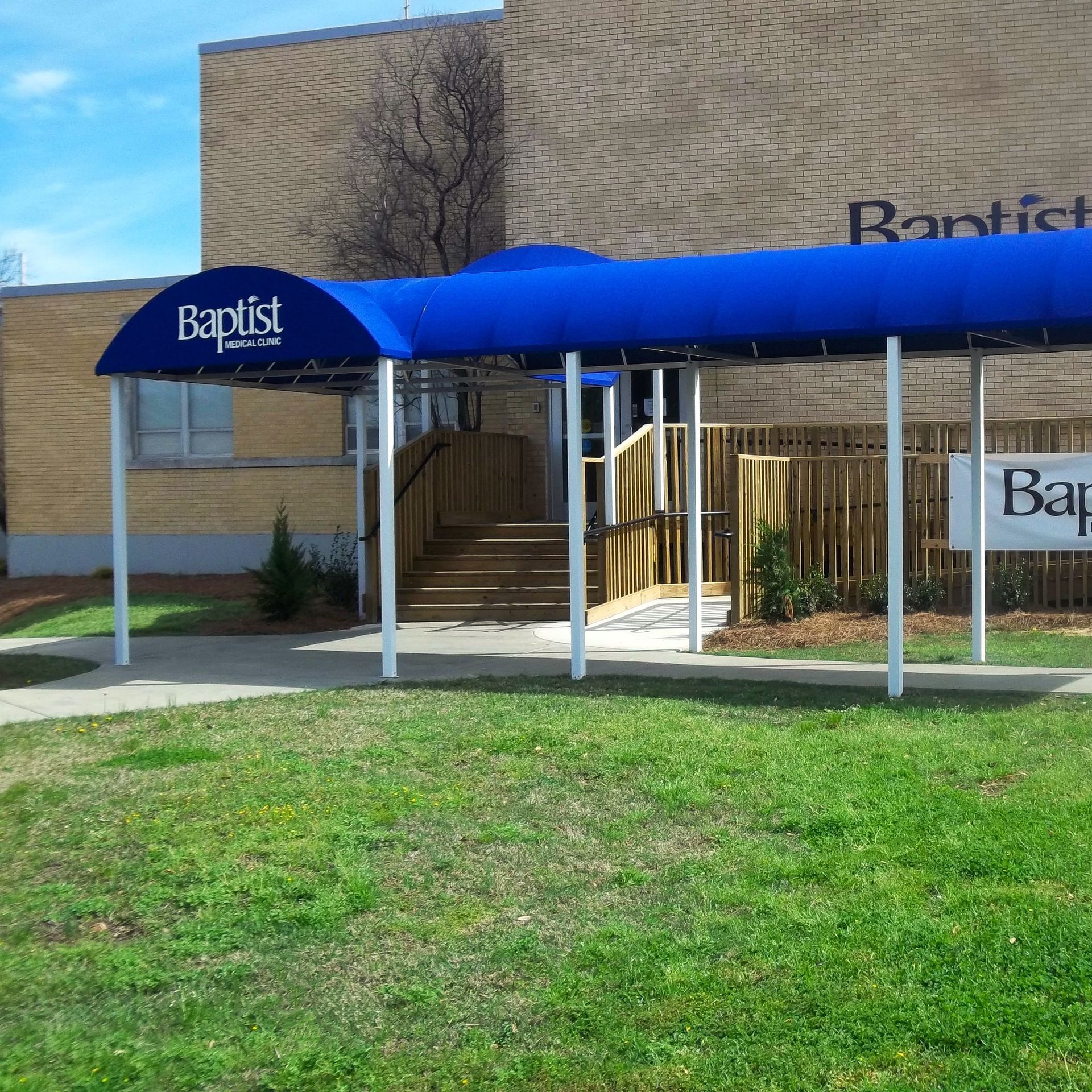 a blue awning with the word baptist on it - Road Jackson, MS - French Awning & Screen Co.