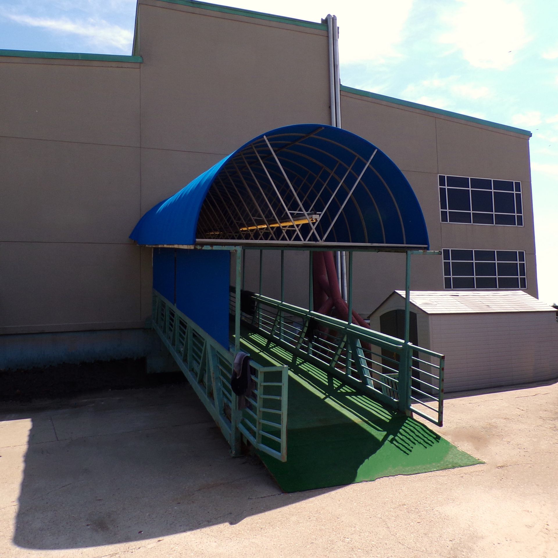 a blue awning over a ramp leading to a building - Road Jackson, MS - French Awning & Screen Co.