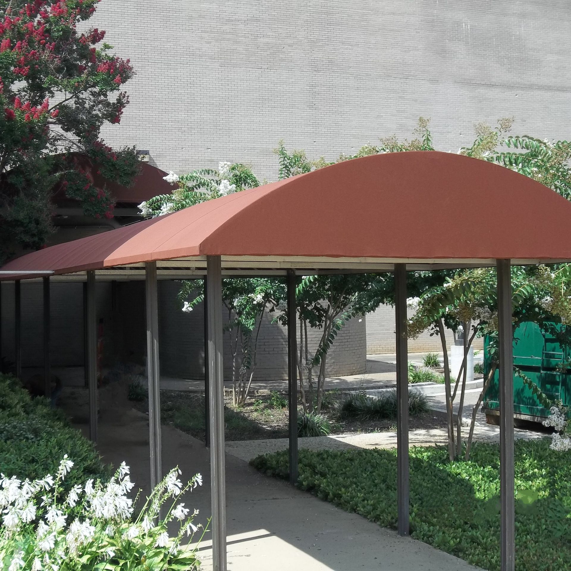 a covered walkway with a red awning over it - Road Jackson, MS - French Awning & Screen Co.