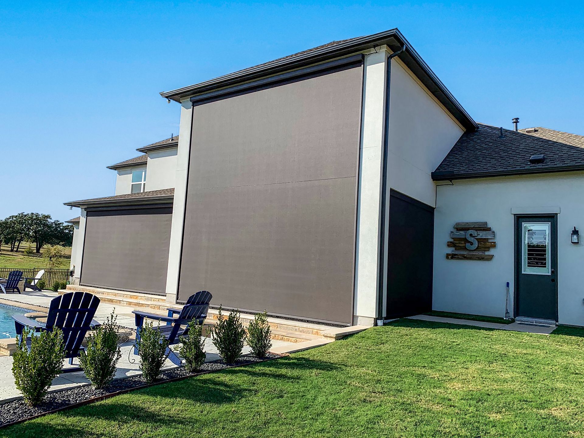 a house with a large screen on the side of it .| Jackson, MS | French Awning an Screen Co