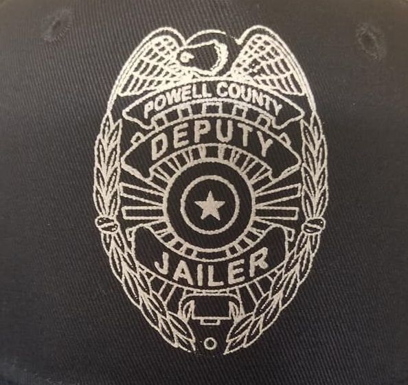 A powell county deputy jailer badge on a black hat
