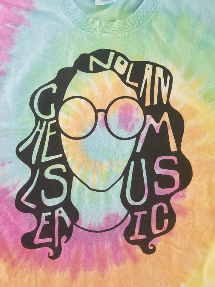 A tie dye t-shirt with a picture of a woman 's face and the word nolan on it