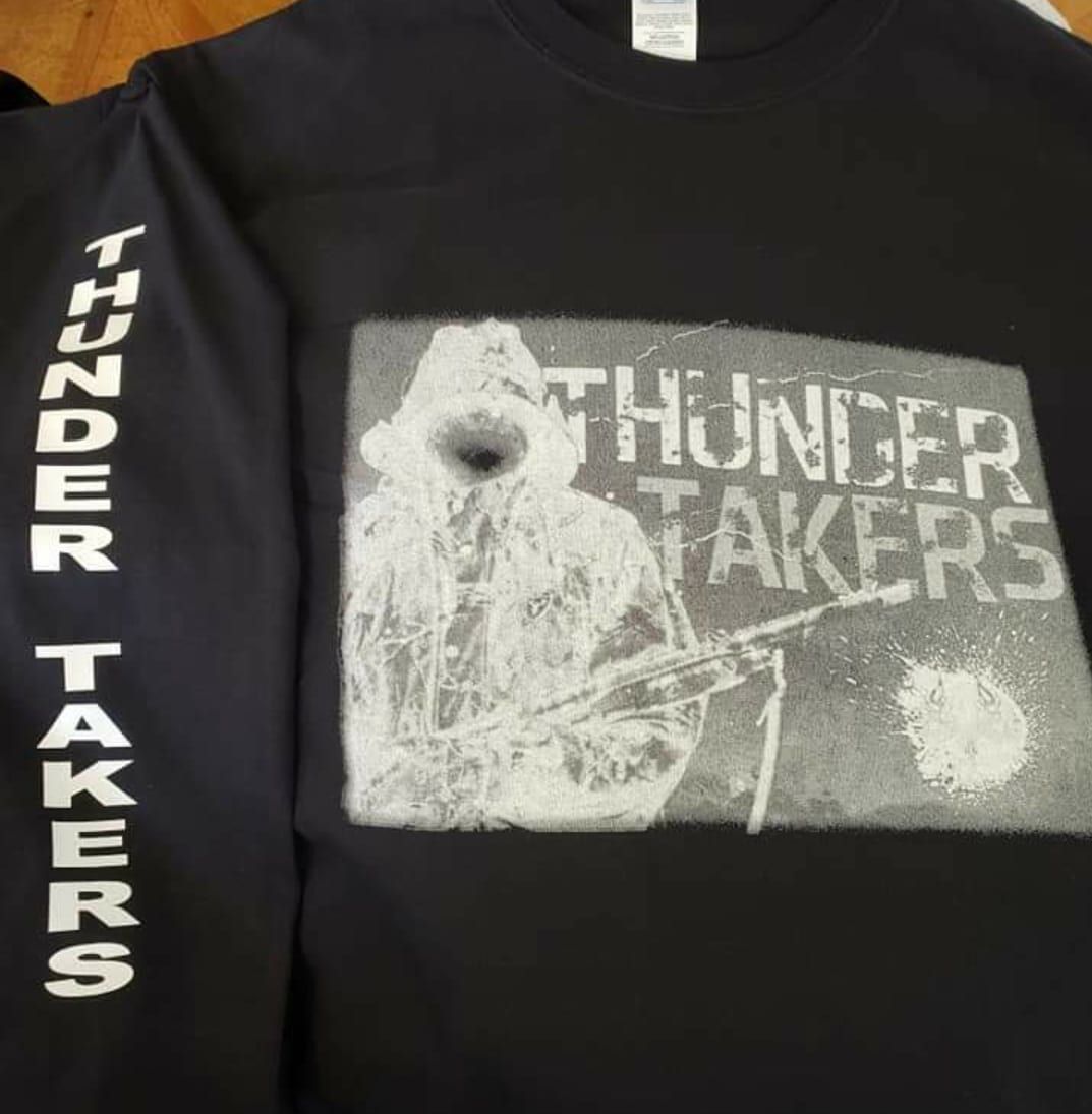 A black shirt with thunder takers on the sleeves