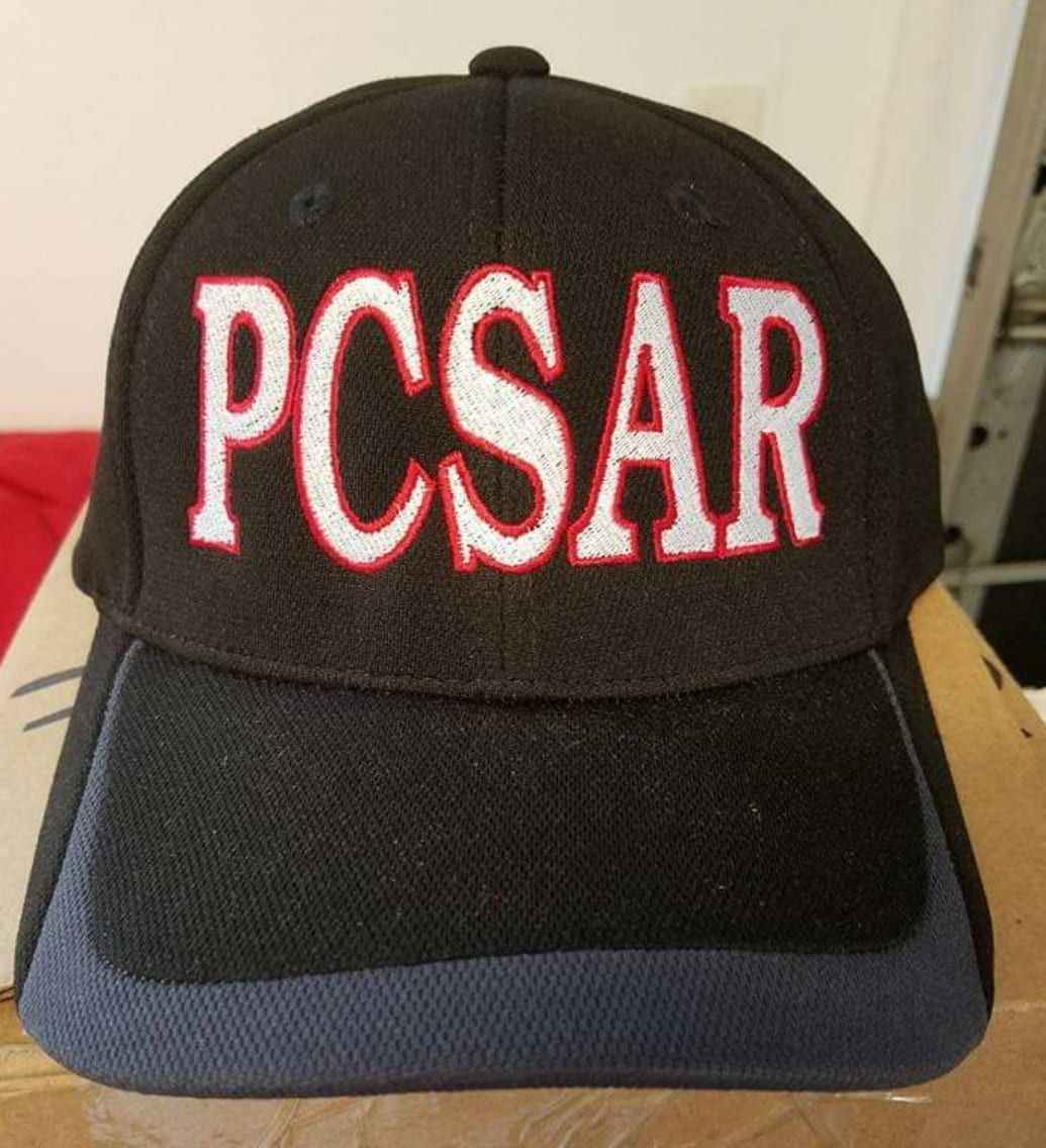 A black hat with the word pcsar embroidered on it