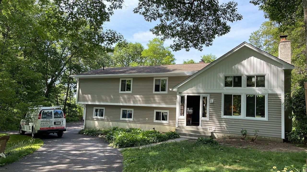 A large house with a lot of windows and a truck parked in front of it.
