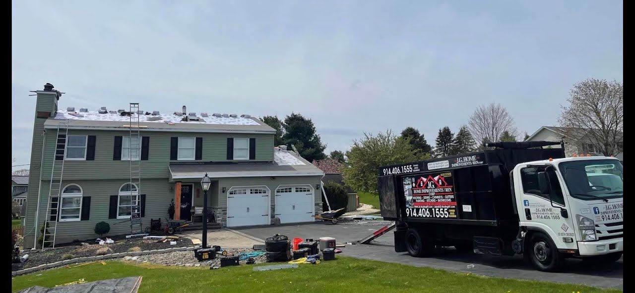 A dump truck is parked in front of a house.