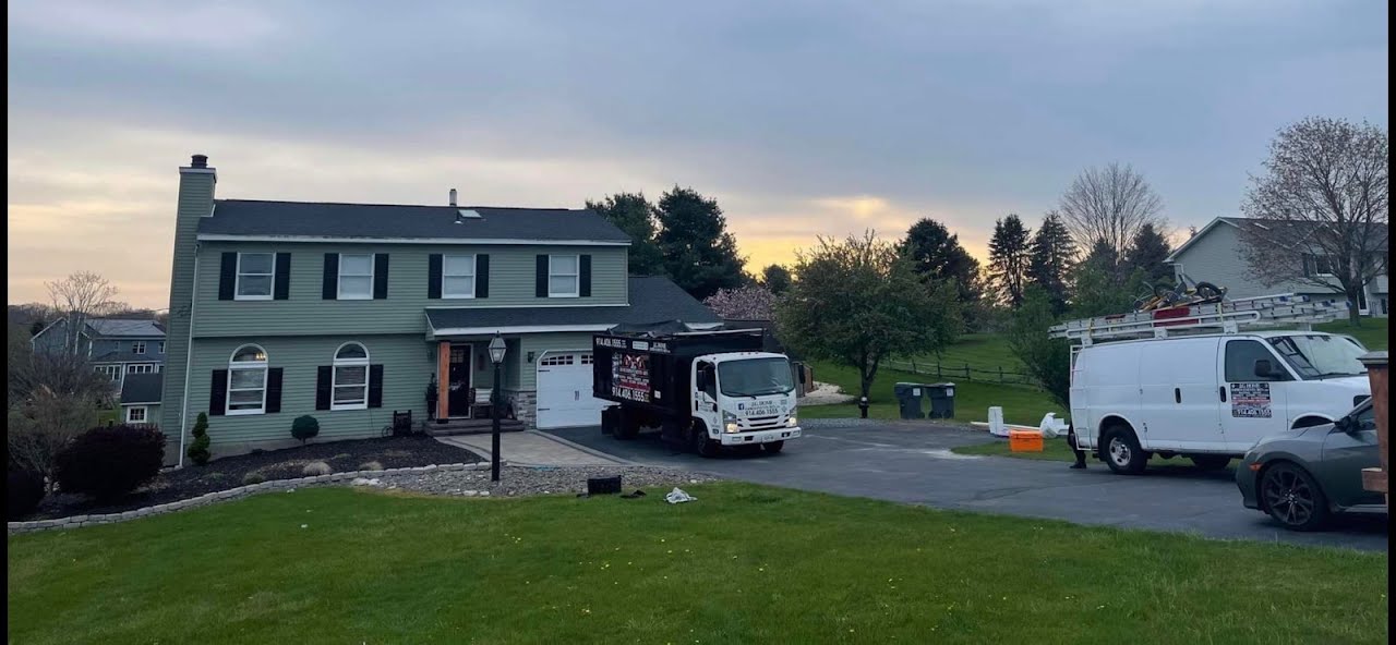 A house with a truck parked in front of it.