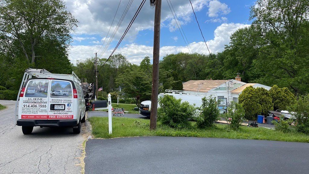 A van is parked on the side of the road in front of a house.