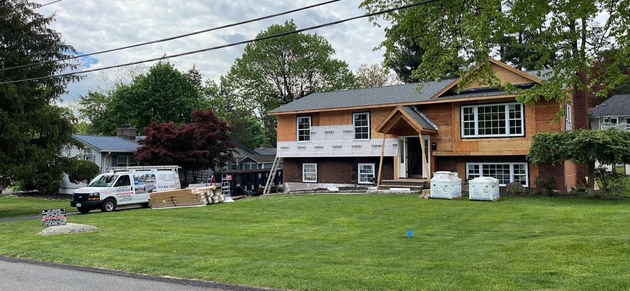 A large house is being remodeled in a residential neighborhood.