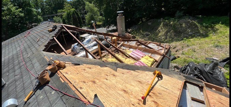 A roof is being repaired with a hammer and a saw.