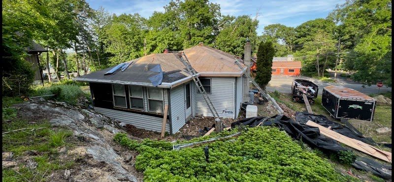 A house is being remodeled with a new roof.