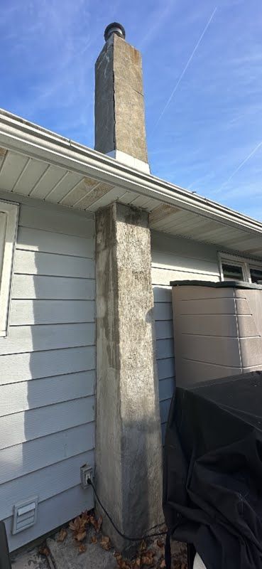 A chimney is sitting on the side of a house.