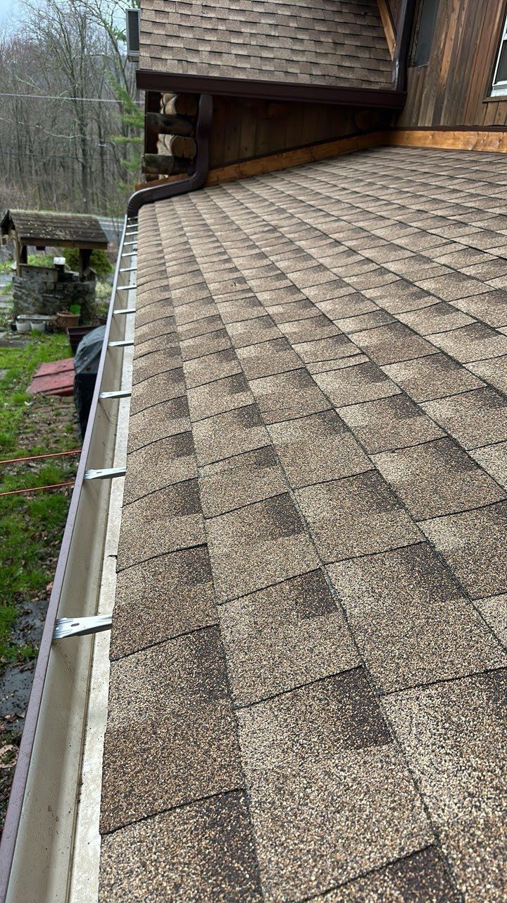 A close up of a roof with a gutter on it.
