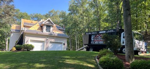 A house with a truck parked in front of it.