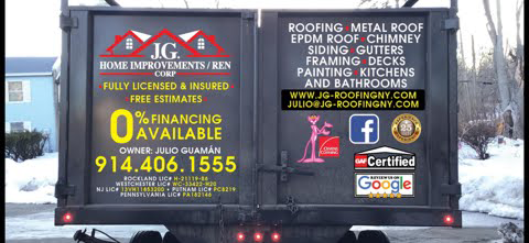 A roofing company truck is parked in the snow.
