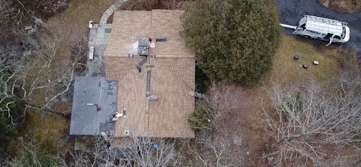 An aerial view of a house with a truck parked in front of it.