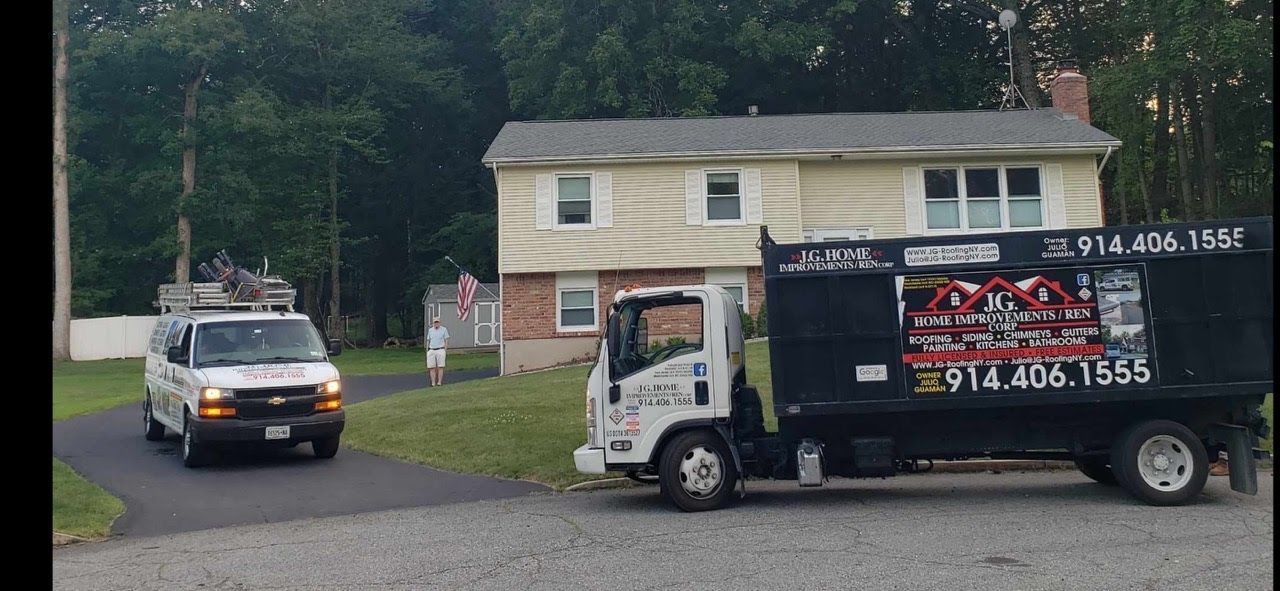 A dump truck is parked in front of a house.