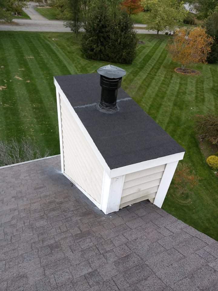 An aerial view of a roof with a chimney on top of it.
