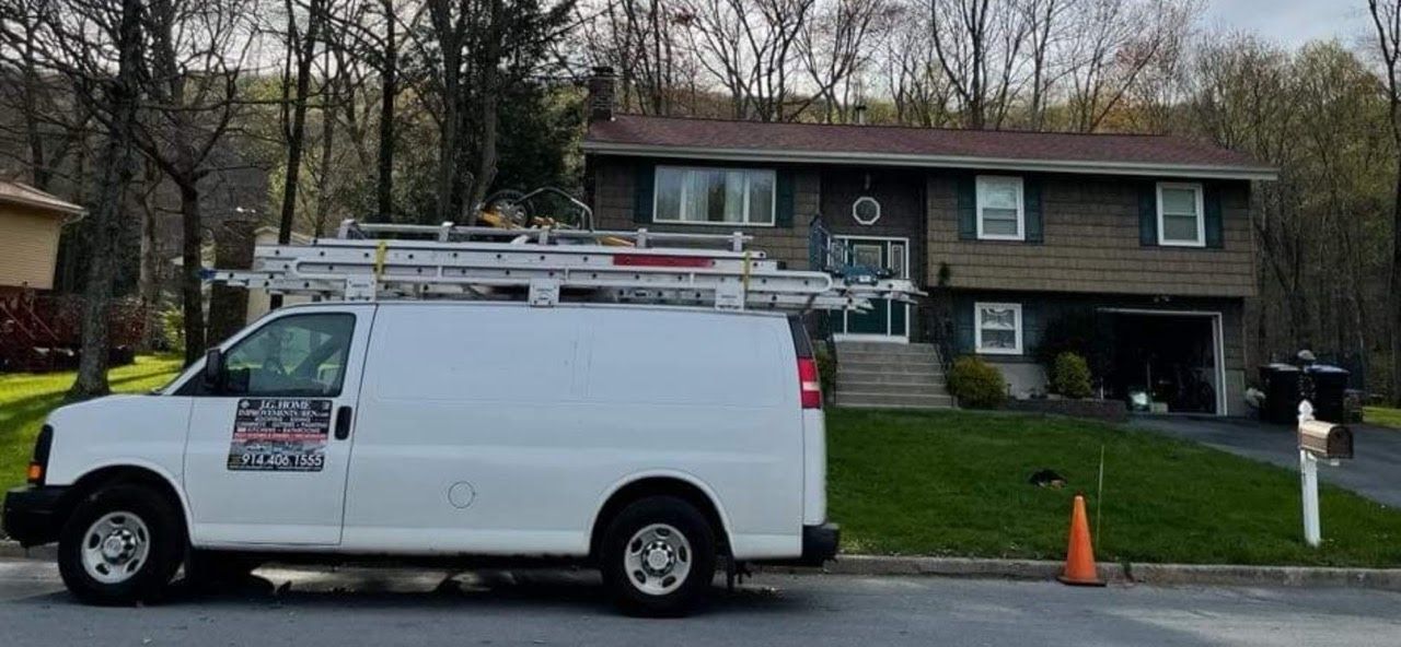 A white van is parked in front of a house.