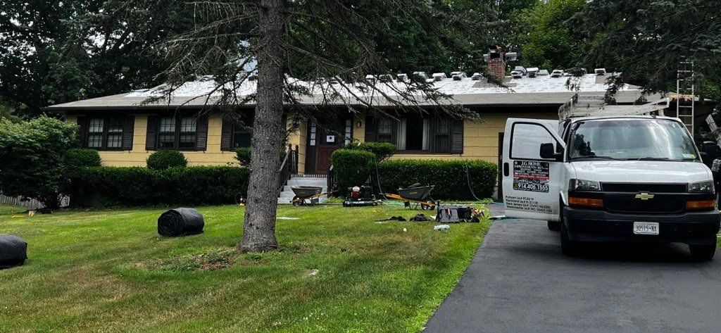 A white van is parked in front of a house.