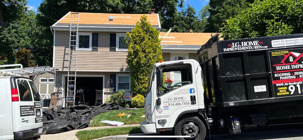 A dump truck is parked in front of a house.