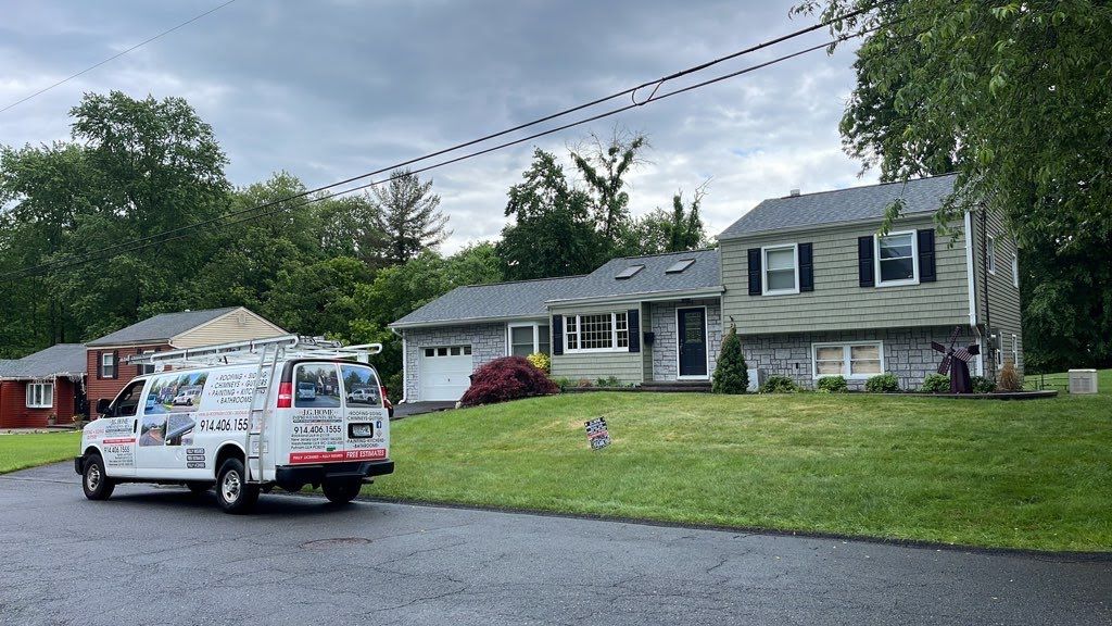 A white van is parked in front of a house.