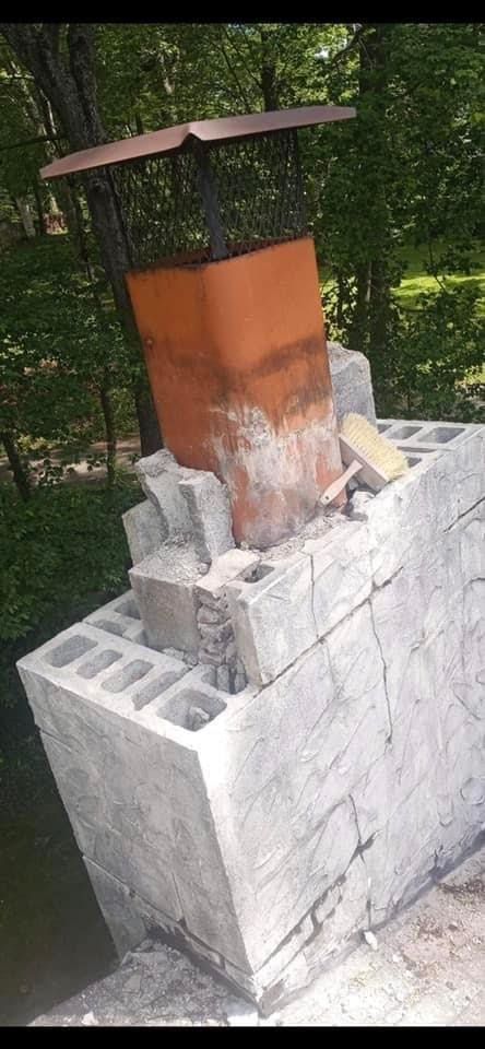 A chimney is being built on top of a concrete block.
