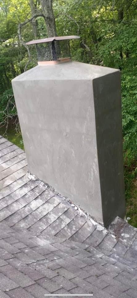 A chimney is sitting on top of a brick roof.