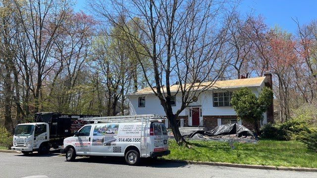A white van is parked in front of a house.