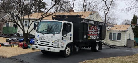 A white truck is parked in front of a house.