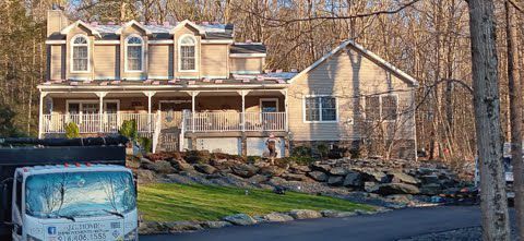 A large house with a truck parked in front of it.