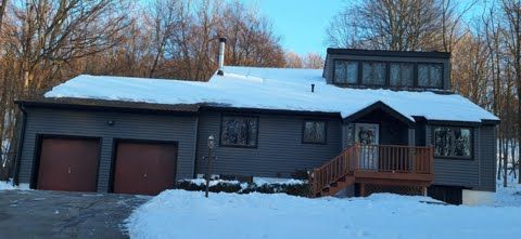 A house with a lot of snow on the roof