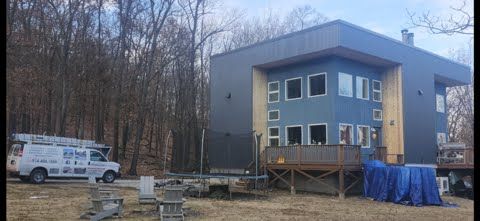 A large house is being built in the middle of a forest.