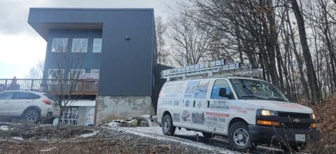 A white van is parked in front of a house.