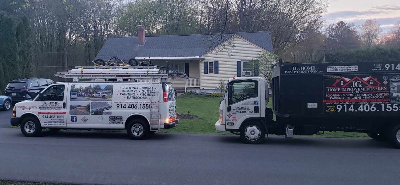 Two trucks are parked in front of a house.