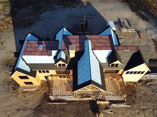 An aerial view of a large house under construction