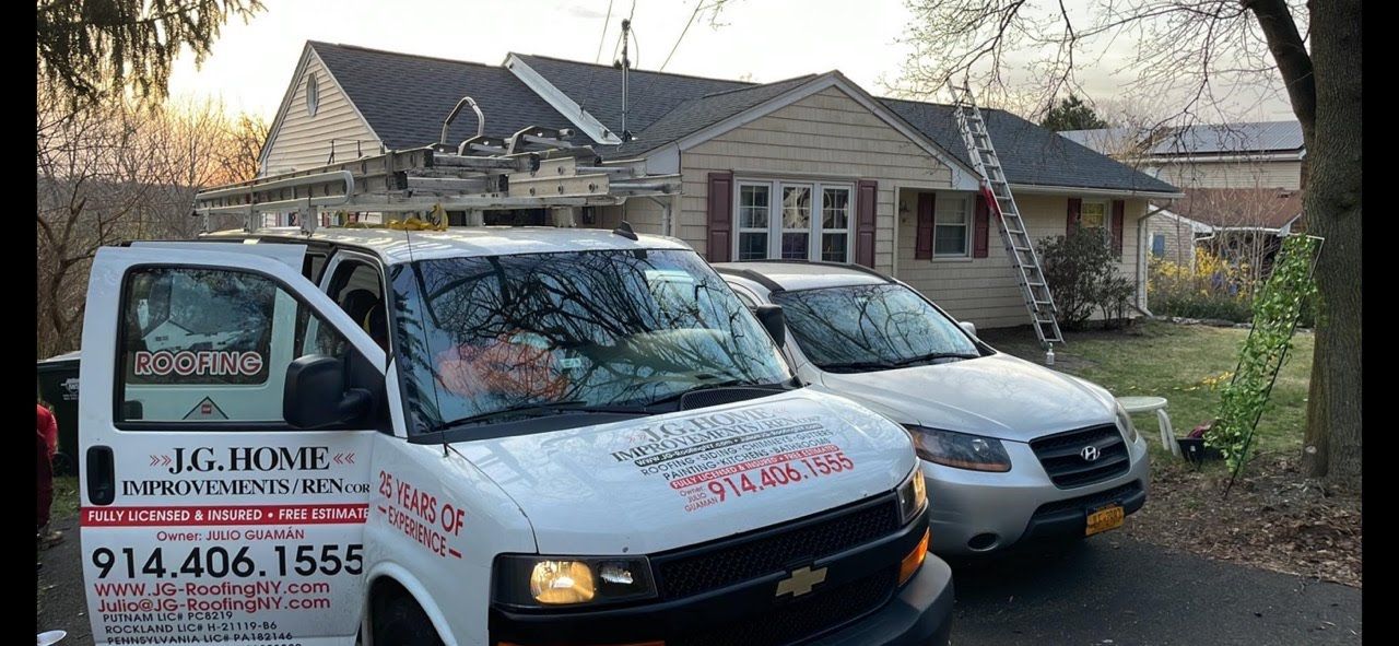 Two vans are parked in front of a house.