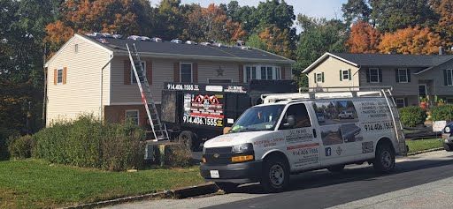 A white van is parked in front of a house.