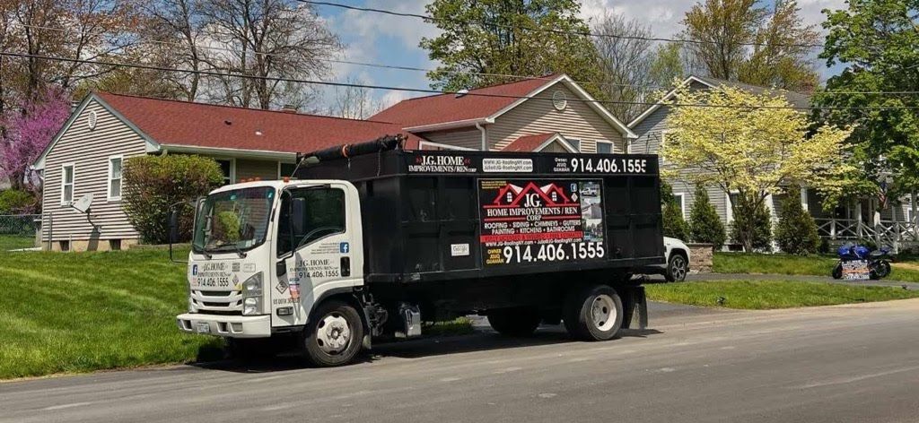 A dump truck is parked in front of a house.