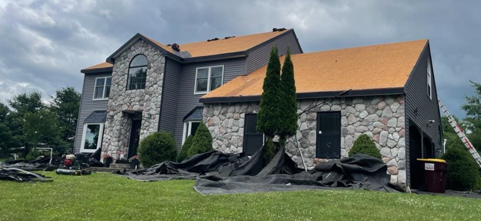 A large house with a roof that is being installed.