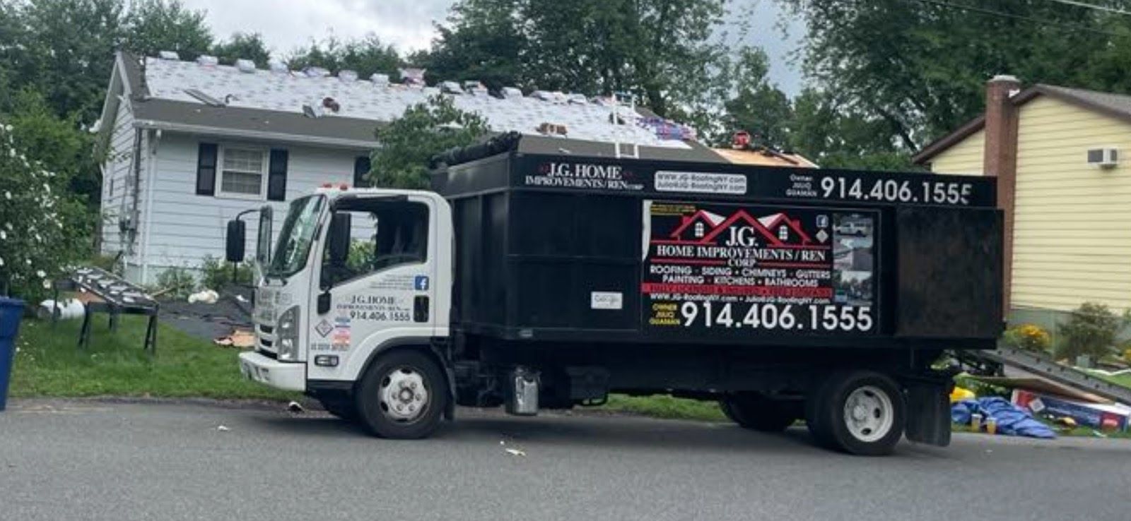 A dump truck is parked in front of a house.