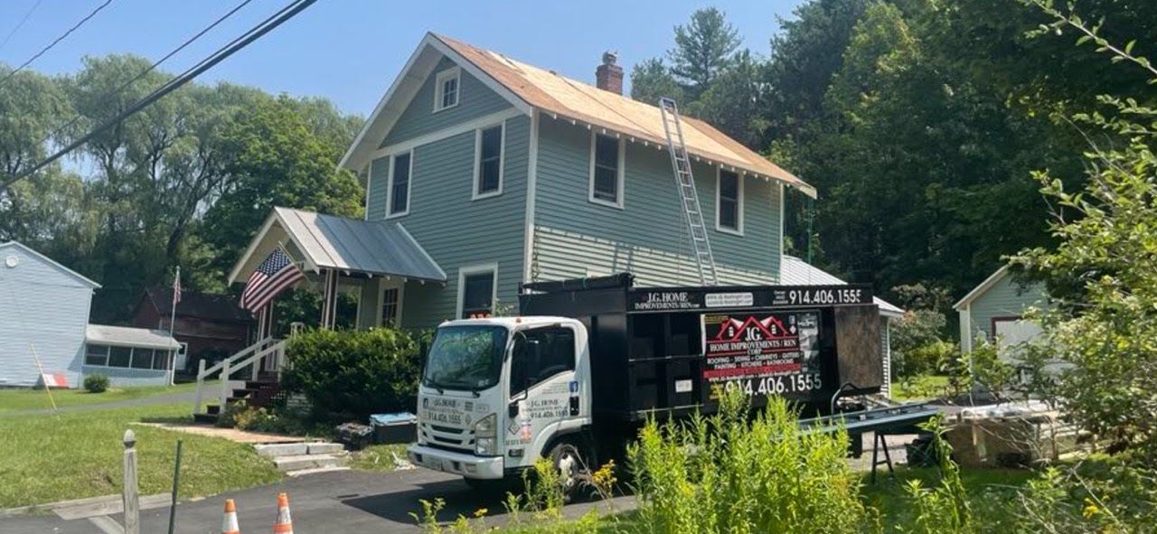 A white truck is parked in front of a house.