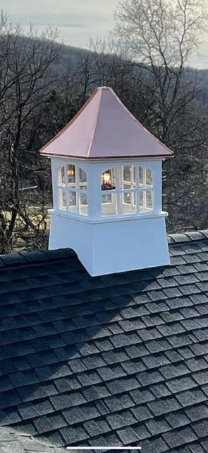 A chimney on top of a roof with a light on it.