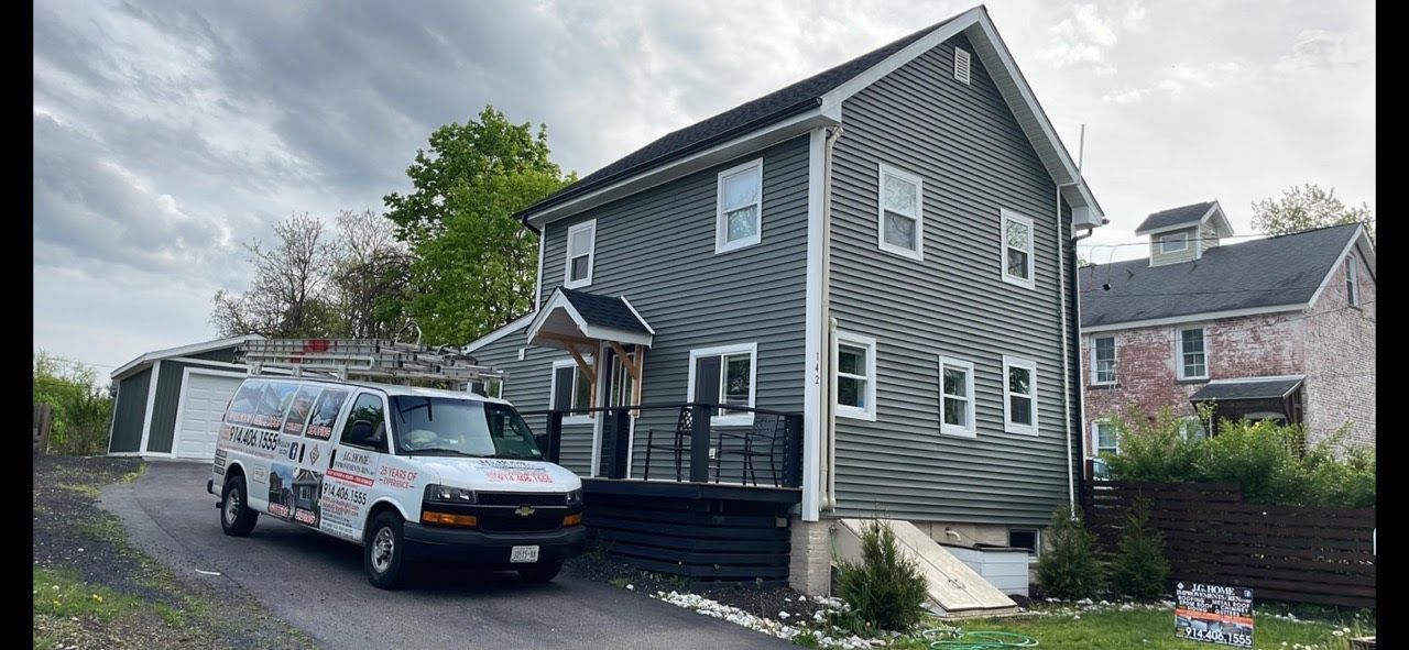 A white van is parked in front of a house.
