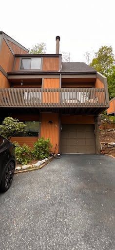 A large house with a car parked in front of it.