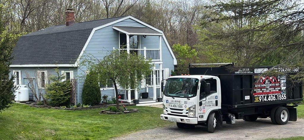 A dump truck is parked in front of a house.