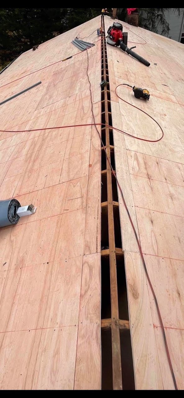 A wooden roof is being built and a drill is sitting on top of it.